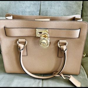 Brand new, never used Michael Kors tan purse with gold features
